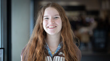 Headshot of Jemima smiling warmly in a University building