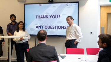 Group of students presenting to a client