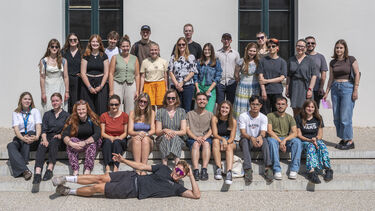 Informal group photo of about 30 students in summary dress 