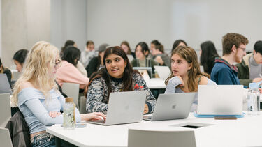 Three women are chatting in the room