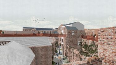 People exploring complex of brick buildings connected by red walkways. 