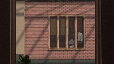 View of person reading in window of brick building