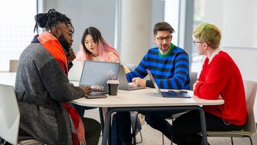 Students working together in the Wave study group study space.