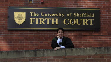 Hao MSc graduate in front of Firth court 