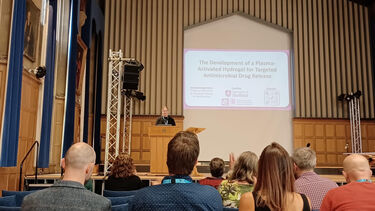 Eleanor Yates presenting to attendees at the symposium