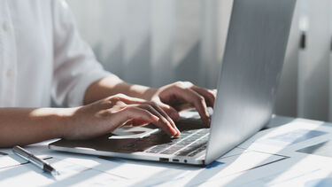 A person typing on a computer keyboard