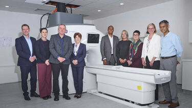 Professor Jim Wild with colleagues in front of an MRI scanner