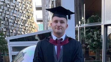 Image of male student Harry baker in his graduation cap and gown