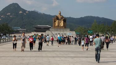 Picture of a temple with a Buda and people