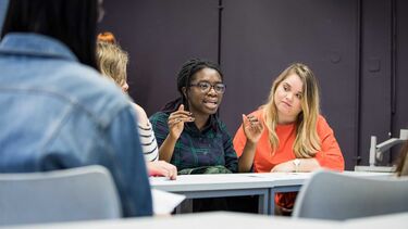 Students sat at a table in discussion