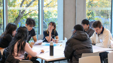 Seven students sat at a table together