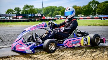 Women in racing kart on track 