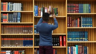 Student getting book from book shelf