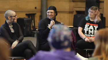 The panel at talking with a microphone at the Drag and the Law event