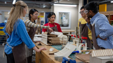 a group of students working on a model in the architecture department