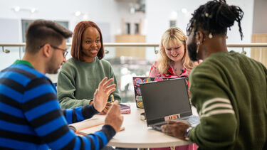 Four students sat round a table in The Wave