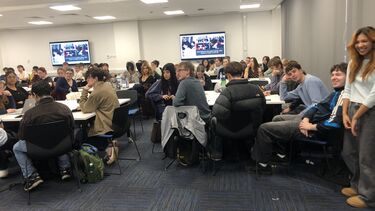 Journalism students sat around tables in a classroom as part of International Journalism Week.