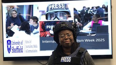 Journalism lecturer in front of a screen showing an International Journalism Week 2025 slide.