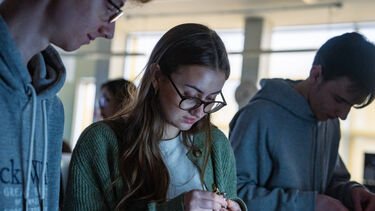 Physics students using equipment