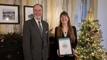 PhD student receiving a certificate