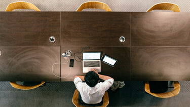 A bird's-eye view of a student studying in the reading room of Western Bank Library