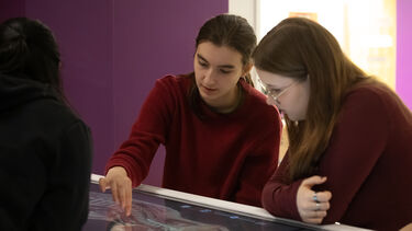 Image shows two female students using anatomage table 