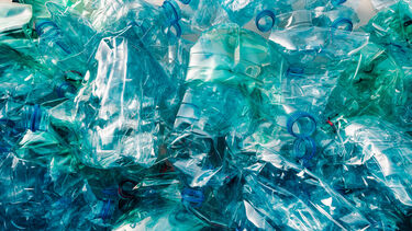 a large pile of crushed up water bottles