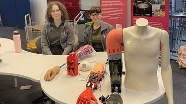 Two female students exhibiting