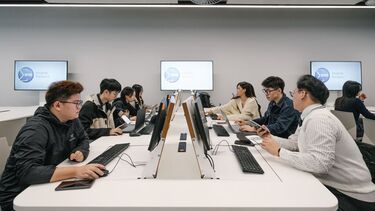 Group of students sitting at computer bank