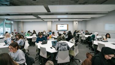 Students sitting at desks in the Wave