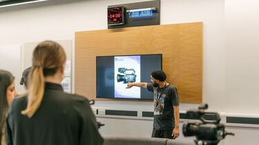 Lecturer showing the components of a camera on a screen