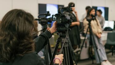 Someone looking at a video camera