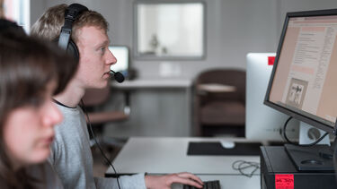 A person attending an online meeting using a desktop computer