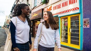Two female walking at Division street.