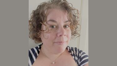 Headshot of Anne-Lise Harding on a grey background