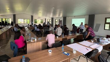 A group of people attend a training session given by Dr Dan Hammett