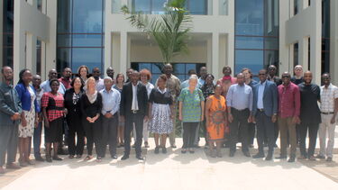 A group photo of the LIBSENSE project community standing outside a large building