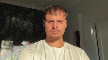 Student Fabian Patel in front of patterned wallpaper