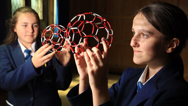 A photo of students holding buckyballs