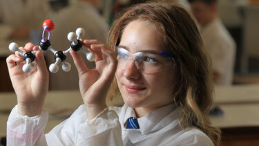 A photo of students holding a molecular model