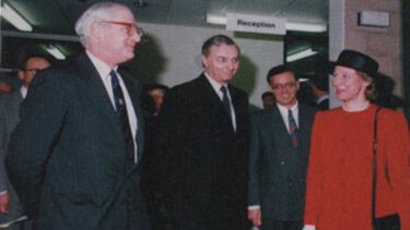 People in formal dress standing in a building reception