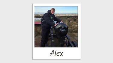 A man standing next to a cannon 