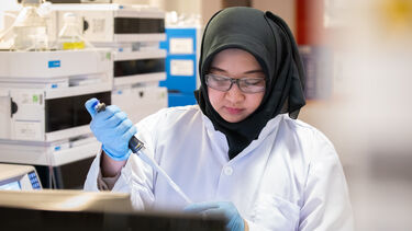 Researcher with a pipette