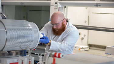 Researcher in PPE conducting an experiment