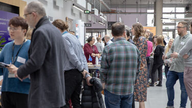 Lots of people looking at exhibition stalls