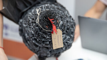 A model chicken with a label tied around its neck