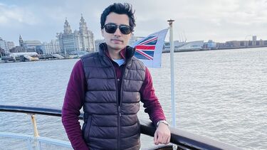 Student Syed Muhammad Ali Abbas Gardezi stood in front of a river and Union Jack flag