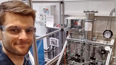 Water engineer in front of a piece of equipment