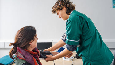 A Pharmacy student checking a patient's blood pressure