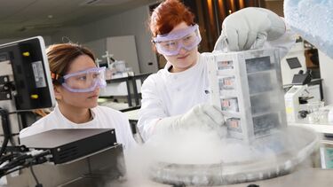 Two scientists examining a buiobank in a lab